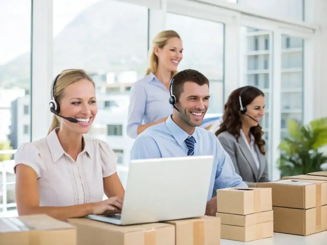 An image showing a Team Rate Shipping staff member assisting a customer with paperwork and packaging, highlighting personalized support and attention to detail during the shipping process.